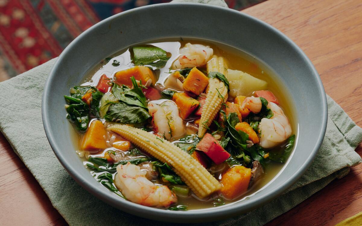 A bowl filled with vegetable and shrimp soup