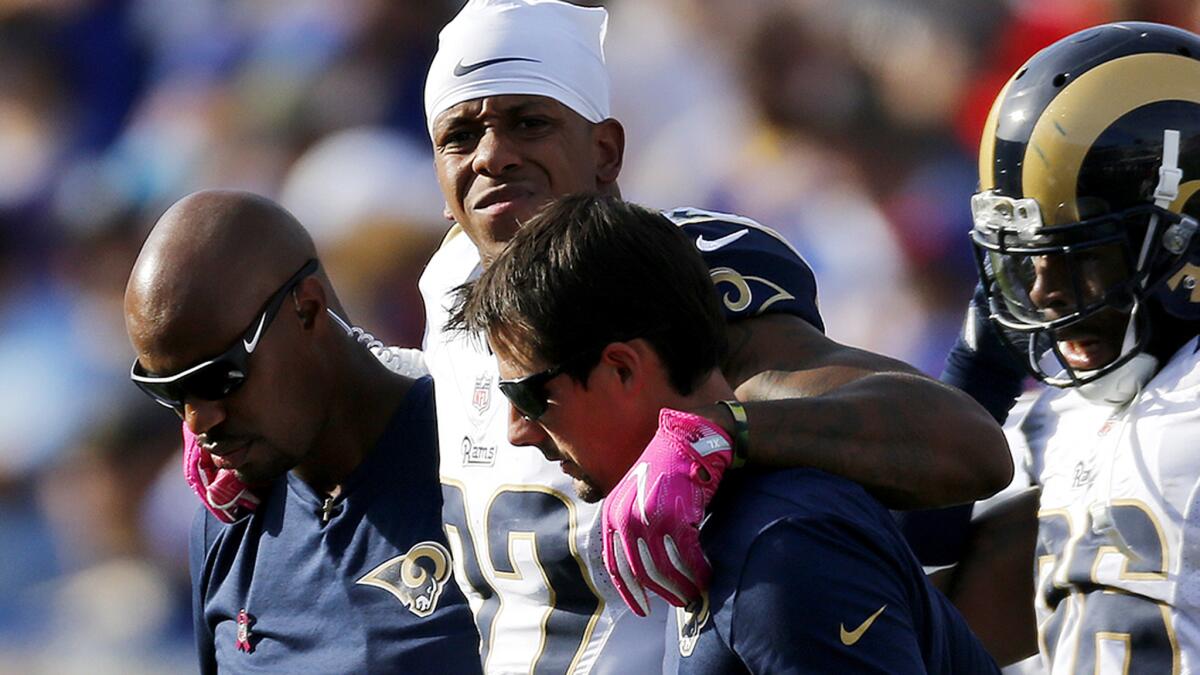 Rams cornerback Trumaine Johnson is helped off the field after suffering an ankle injury Sunday while playing against the Buffalo Bills.