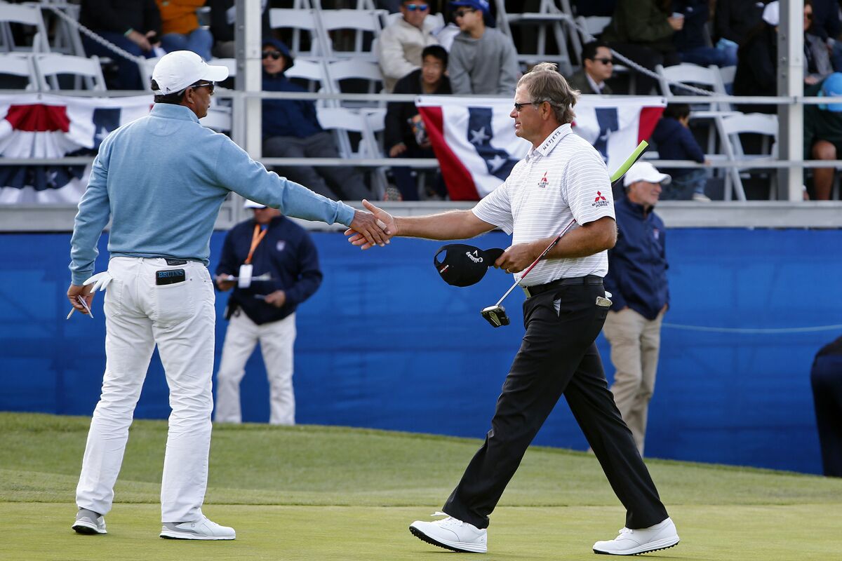Retief Goosen, right, shakes hands with Tom Pernice Jr. after they finish the 18th hole.