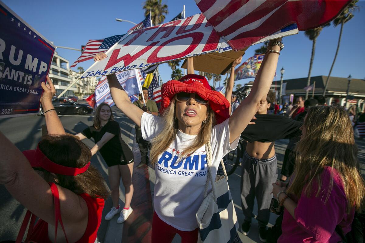 Trump supporters gather for an anti-mask "freedom march" in Huntington Beach on Monday, June 14.