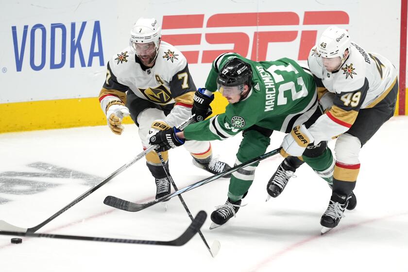 Dallas Stars left wing Mason Marchment (27) makes a pass to the front of the net as Vegas Golden Knights' Alex Pietrangelo (7) and Ivan Barbashev (49) defend in the third period in Game 1 of an NHL hockey Stanley Cup first-round playoff series in Dallas, Monday, April 22, 2024. (AP Photo/Tony Gutierrez)