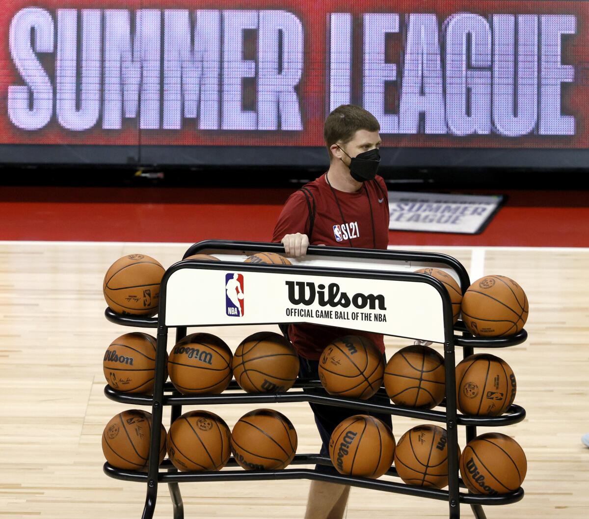 A rack of basketballs is wheeled off the court before Las Vegas Summer League game at the Thomas & Mack Center.
