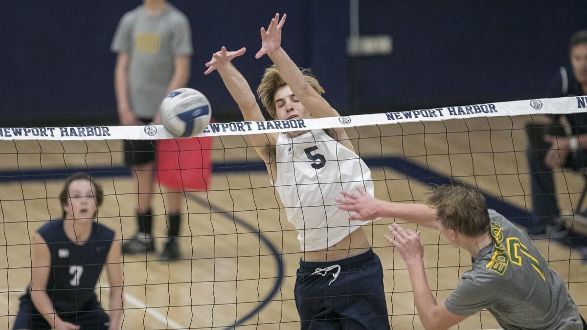 Cole Pender, shown blocking a shot on March 30, led Newport Harbor High to a 20-25, 25-22, 25-17, 25-9 win at Mission Hills Alemany in the quarterfinals of the CIF Southern Section Division 1 playoffs on Saturday.