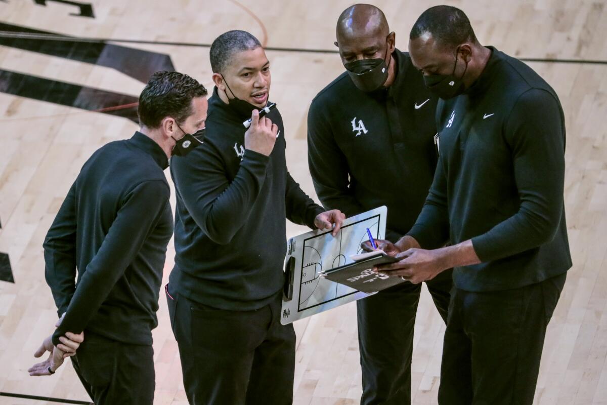 Clippers coach Tyronn Lue (second from left) talks to assistants during Game 1.