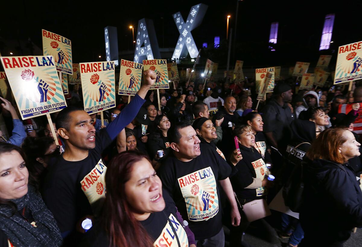 Hundreds of airline catering workers protest against LSG Sky Chefs and its subsidiary Gate Gourmet, calling for higher wages and improved healthcare benefits during a march at Los Angeles International Airport on Tuesday.