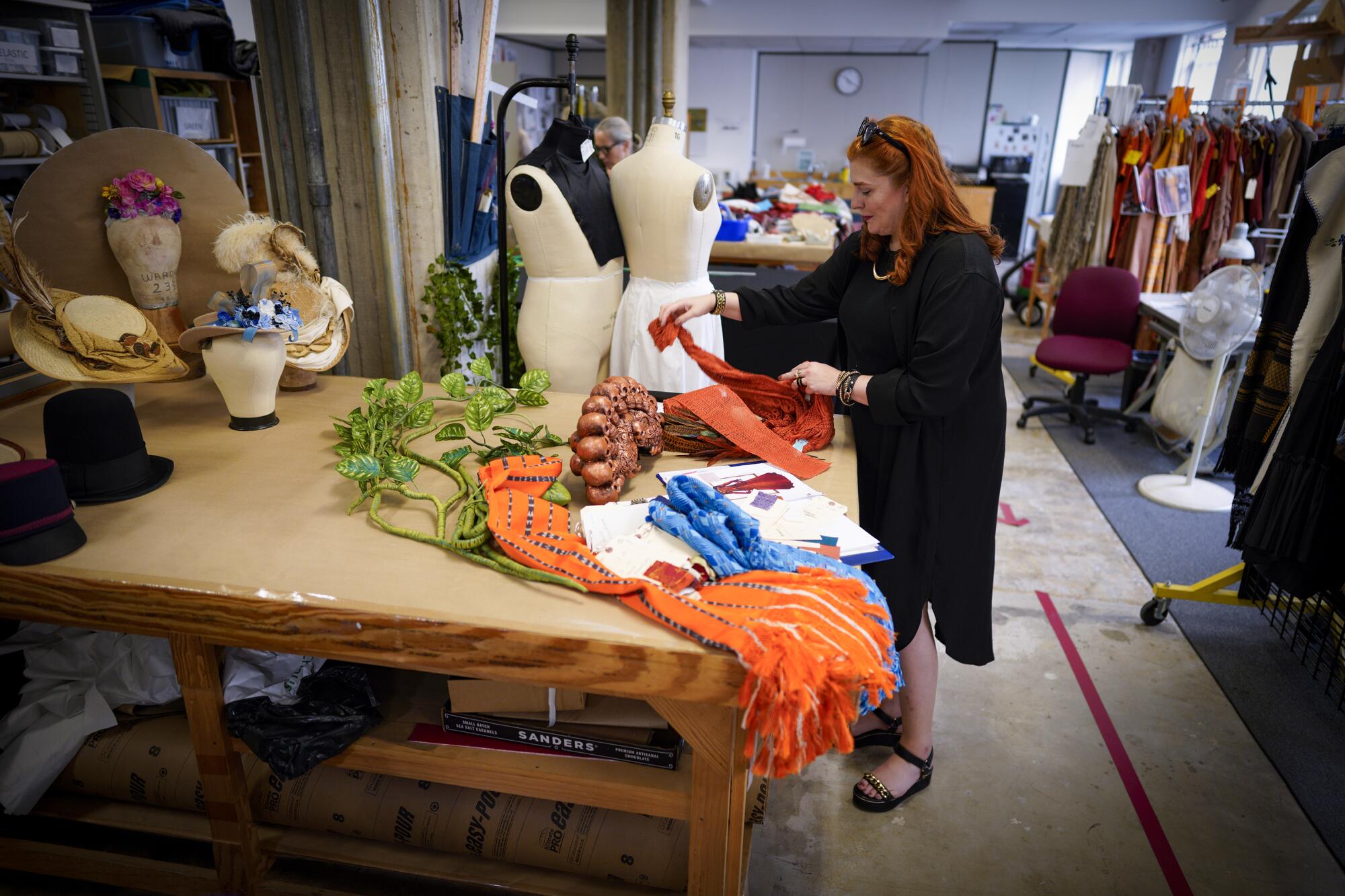 Costume designer Eloise Kazan looks over fabrics at the San Diego Opera Costume Shop.