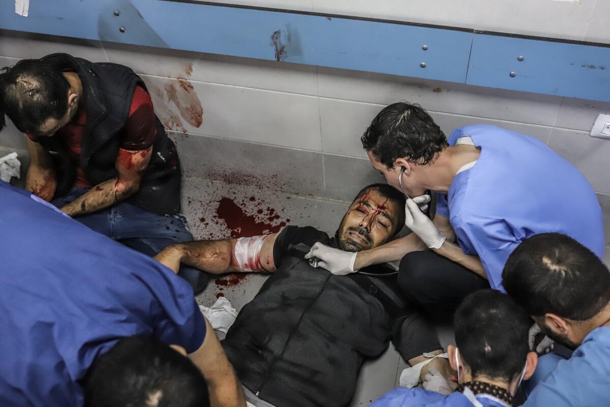 Injured people receiving medical attention at Shifa Hospital in Gaza