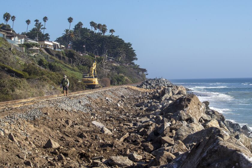 San Clemente, CA - September 21: Metrolink and Amtrak have been forced to suspend service between Orange and San Diego counties for several weeks as crews conduct emergency repairs caused by beach erosion in San Clemente Tuesday, Sept. 21, 2021. The Cyprus Shores gated community, shown at left, has been impacted by erosion and the La Casa Pacifica (previously owned by President Richard Nixon) located in the gated community of Cottons Point Estates/Cypress Shores upper-middle of photo, located at Cotton's Point. (Allen J. Schaben / Los Angeles Times)