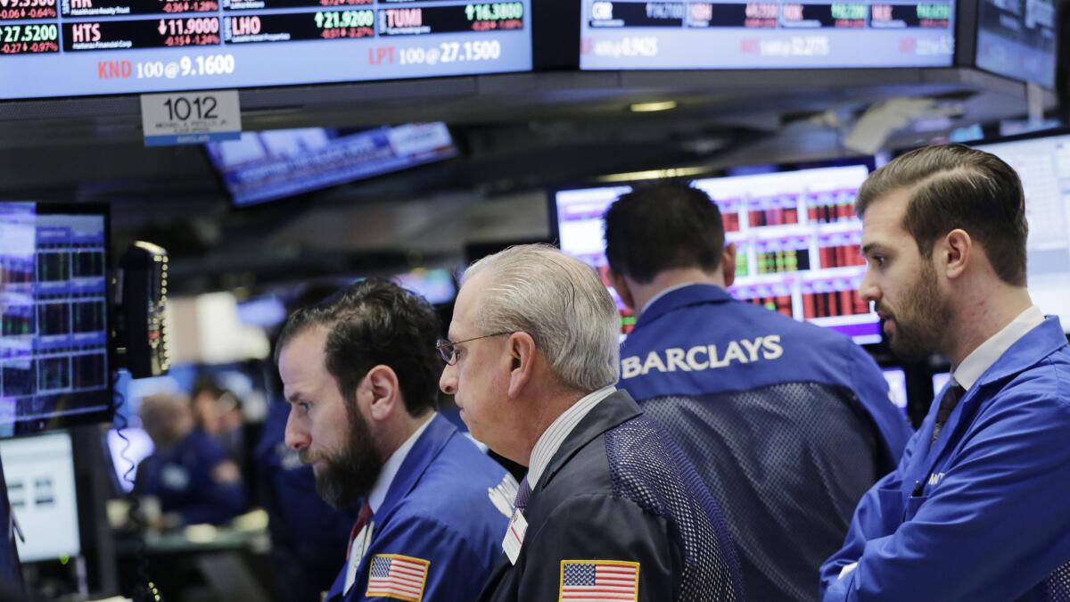 Traders work at the New York Stock Exchange on Thursday.