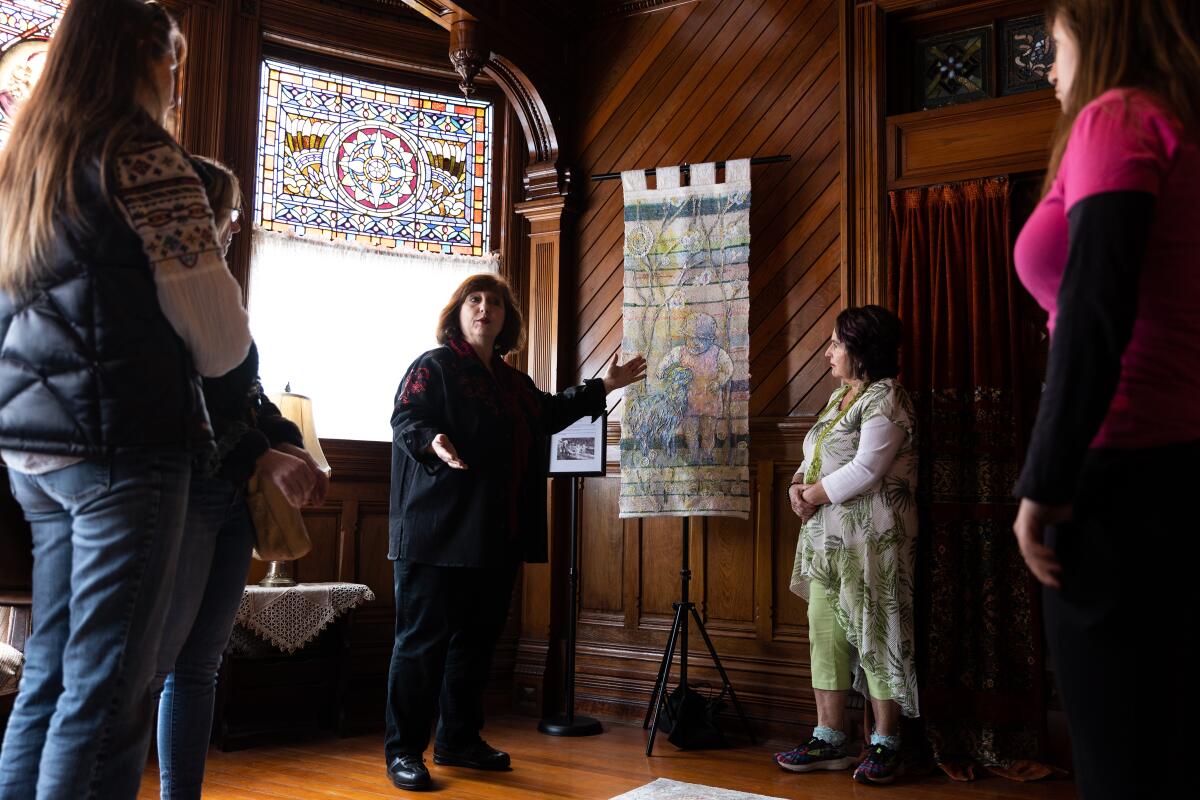 Louise Torio, president of Friends of the Villa Montezuma, gives a tour of the “HeART and Soul of Ukraine” exhibit.