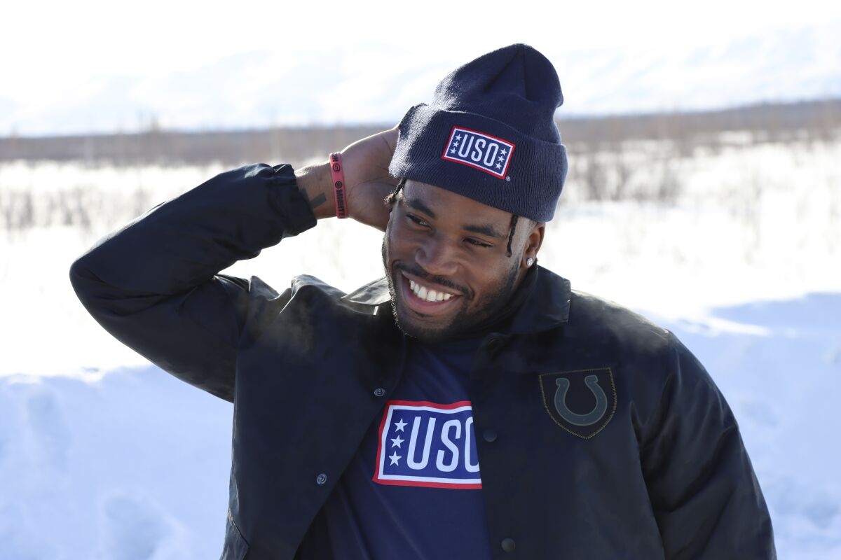 In a photo provided by the NFL, Indianapolis Colts' Kenny Moore smiles near Fairbanks, Alaska, April 5, 2022, during the 2022 NFL-USO Tour. Moore was awestruck by the conditions military members must battle. And by their resolve and resourcefulness — things any pro athlete can identify with. (NFL via AP)