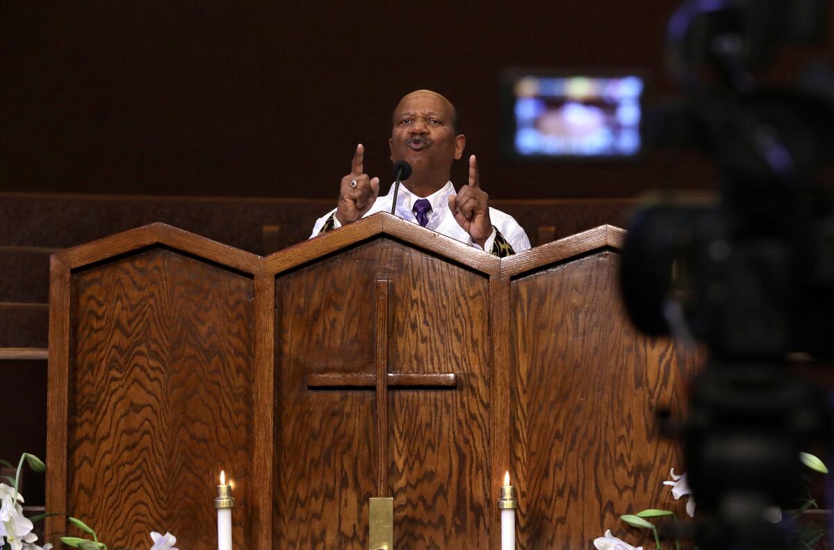 Pastor J. Edgar Boyd films at First AME church.