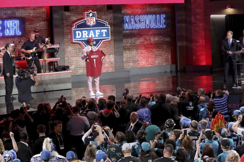 Kyler Murray poses with a jersey after being selected by the Arizona Cardinals with the first pick during the first round of the NFL football draft, in Nashville, Tenn. on Thursday, April 25, 2019. (AP Photo/Gregory Payan)