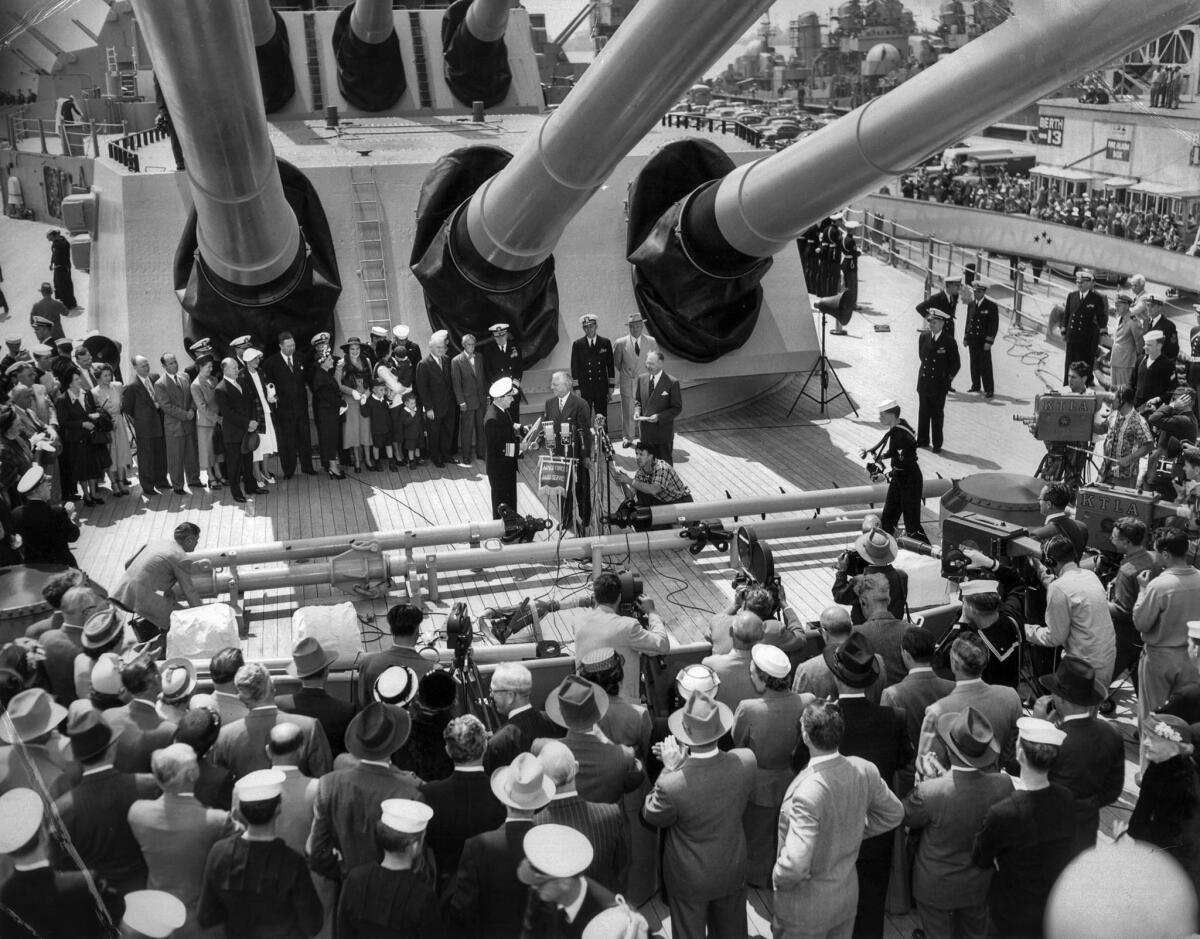 April 12, 1951: Ceremonies on the Missouri in Long Beach following deployment to Korean War. Beneath the 16-inch guns of the battleship, Mayor Burton Chace of Long Beach welcomes Vice Adm. Arthur D. Struble, former commander of the 7th Fleet.