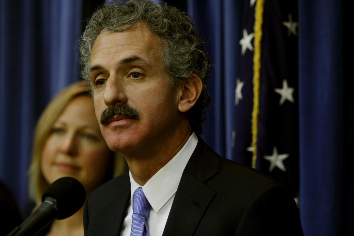 Los Angeles City Atty. Mike Feuer, seen at a news conference last month, is suing a gambling systems firm for allegedly supplying local cyber cafes.