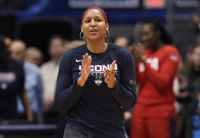Former Connecticut player and Minnesota Lynx Maya Moore acknowledges crowd reaction before a 2020 game in Hartford, Conn.