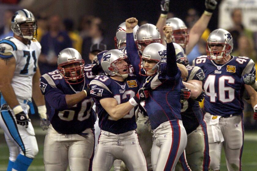Patriots kicker Adam Vinatieri celebrates after kicking a 41-yard field goal in the fourth quarter to beat the Panthers in Super Bowl XXXVIII.