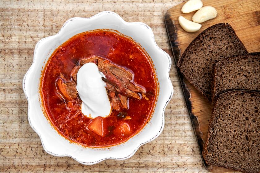 LOS ANGELES, CA - MARCH 04: Ukrainian borscht with dark bread, garlic and sour cream made by Marina Yusim at her home in Studio City on Friday, March 4, 2022 in Los Angeles, CA. (Mariah Tauger / Los Angeles Times)