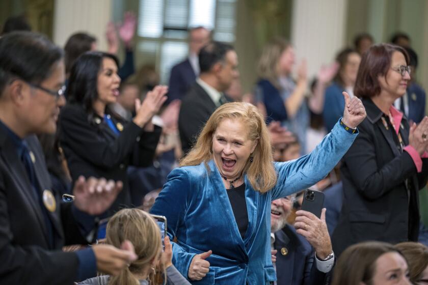 Assemblymember Gail Pellerin, of District 28, celebrates after being sworn in during the opening session of the California Legislature in Sacramento, Calif., Monday, Dec. 5, 2022. The legislature returned to work to swear in new members and elect leaders for the upcoming session. (AP Photo/José Luis Villegas, Pool)