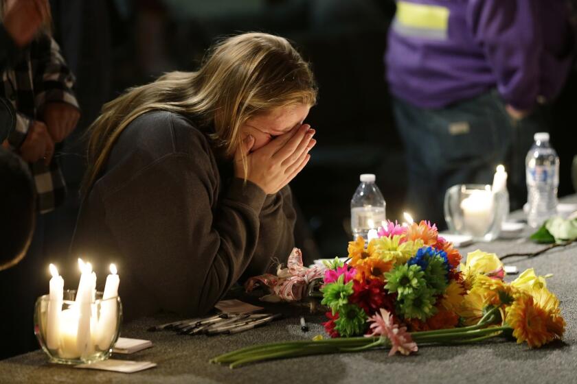 A woman grieves at a vigil at Grove Church in Marysville, Wash., held for victims of the shooting at Marysville-Pilchuck High School.