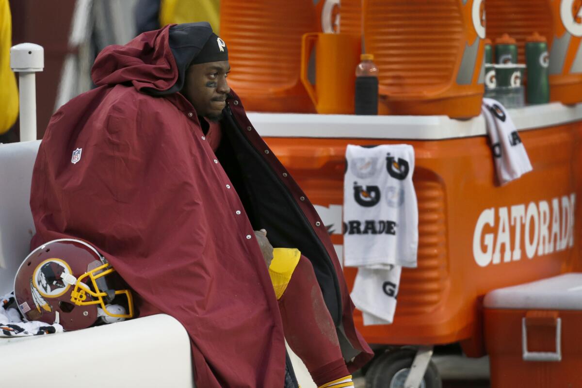 Washington quarterback Robert Griffin III sits on the bench during the Redskins' game against the Dallas Cowboys on Dec. 28.