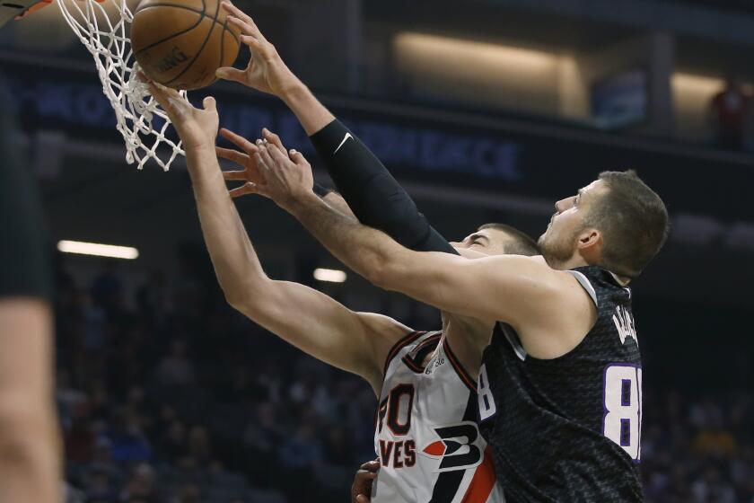 Clippers center Ivica Zubac as the inside track for a rebound against Kings forward Nemanja Bjelica during the first half of a game Dec. 31, 2019.