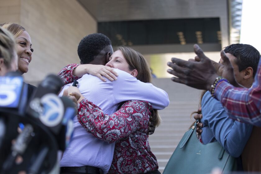 LOS ANGELES, CA - JULY 27: Assistant U.S. Atty. Lindsay Bailey hugs surviving victim Dane Brown following Ed Buck's guilty verdict on Tuesday, July 27, 2021 in Los Angeles, CA. (Myung J. Chun / Los Angeles Times)