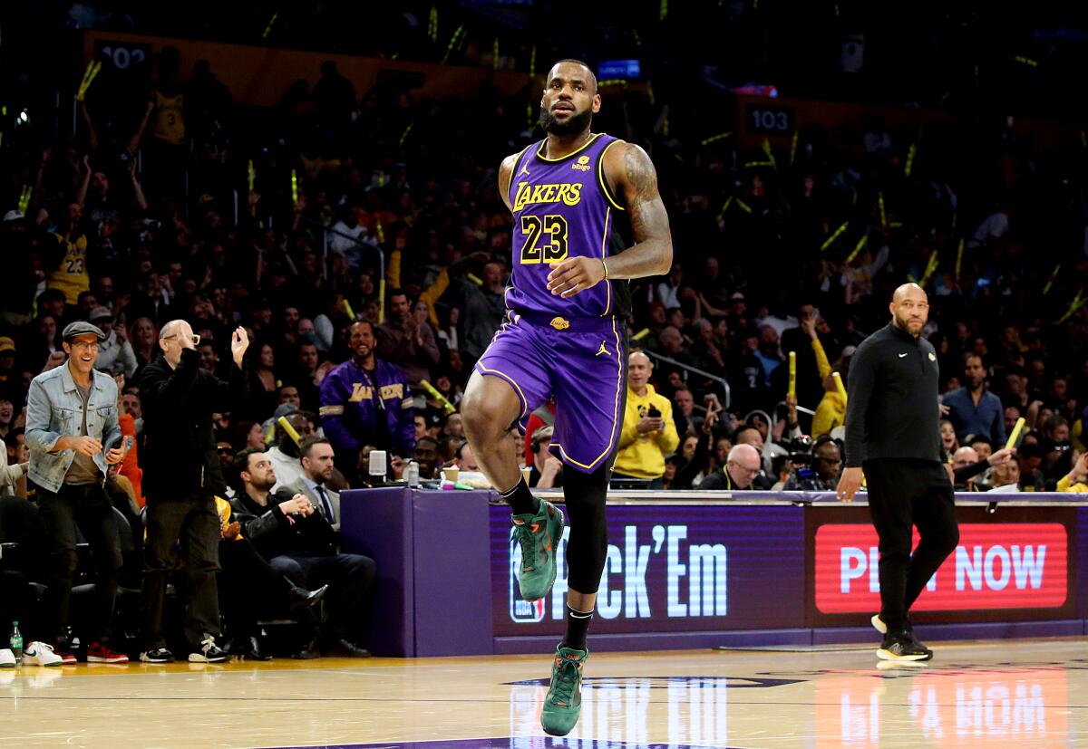 Lakers coach Darvin Ham watches as LeBron James skips across the court after hitting a three-pointer against Memphis.