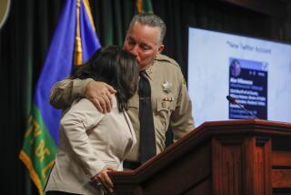 Los Angeles, CA, Tuesday, November 15, 2022 - LA County Sheriff Alex Villanueva details his accomplishments during a press conference at the Hall of Justice. He embraces his wife, Vivian as the presentation nears the end. (Robert Gauthier/Los Angeles Times)