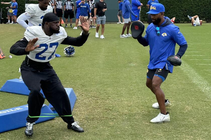 Rams cornerback Tre’Davious White works with defensive backs coach Aubrey Pleasant.