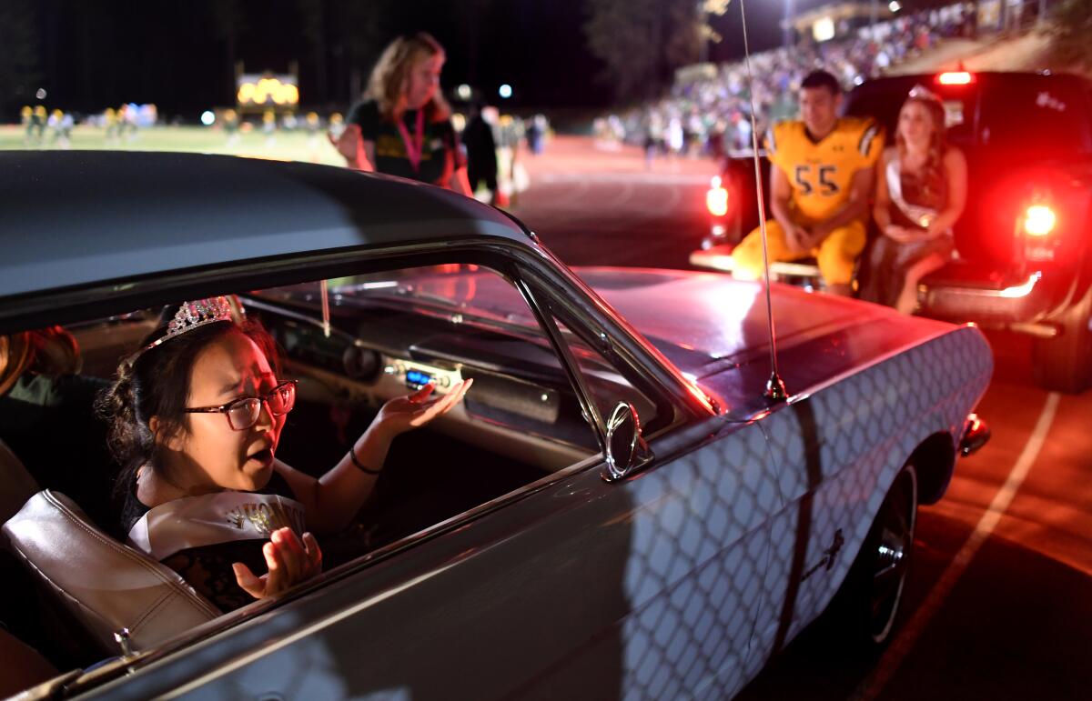 Paradise High School homecoming princess Kelly Wang talks to friends during ceremonies Friday night in Paradise.