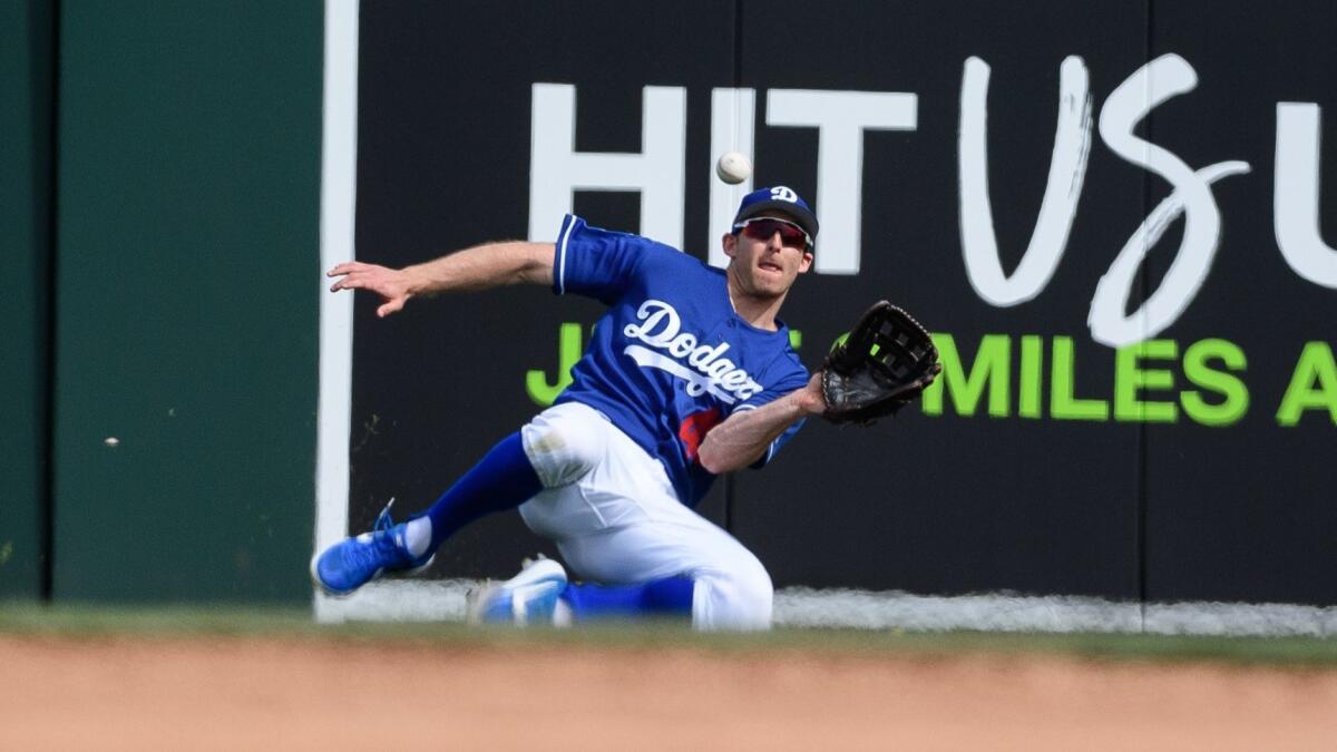 Brad Miller of the Dodgers catches a fly ball against the Seattle Mariners at Camelback Ranch on March 9, 2019.