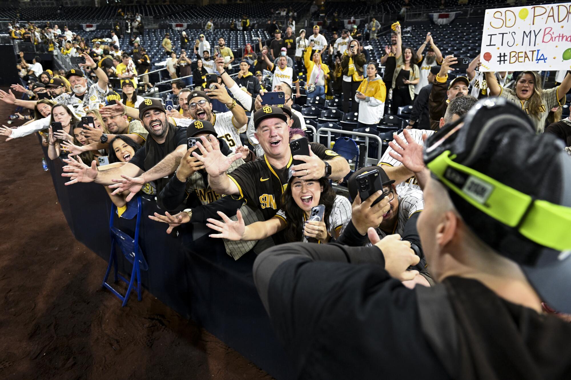 San Diego Padres fans celebrate after the Padres beat the Los Angeles Dodgers 5-3 in game 4 of the NLDS.