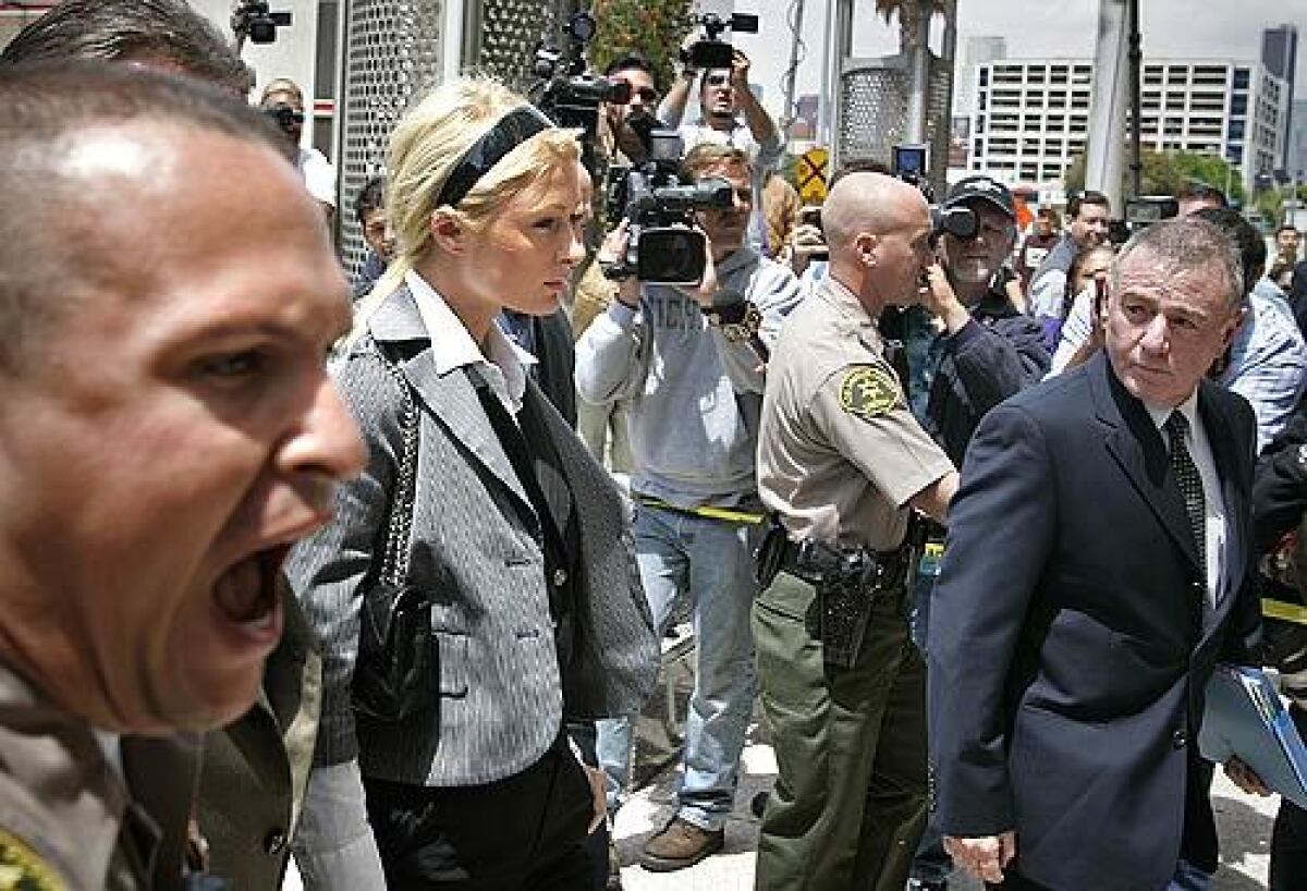 Sheriff's deputies create a wider berth between photographers and Paris Hilton and her lawyer Howard Weitzman.