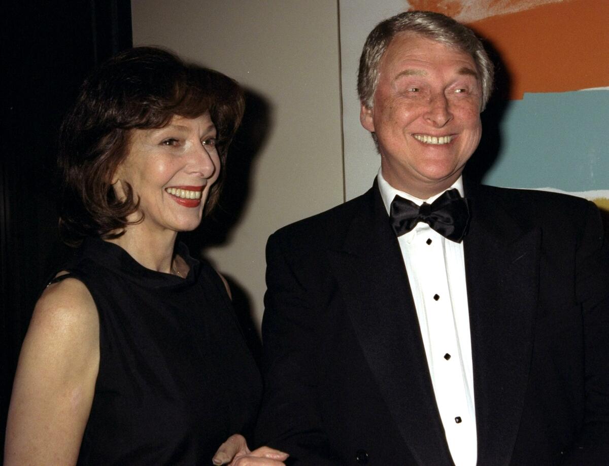 Mike Nichols and Elaine May, dressed in black formal wear, smile.