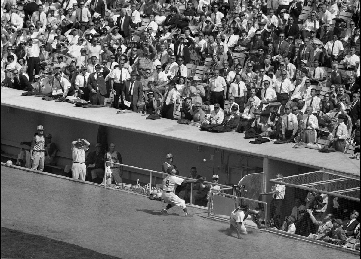 Dodgers first baseman Ron Fairly catches a foul popup by Frank Robinson on April 10, 1962, during the first game at Dodger Stadium.