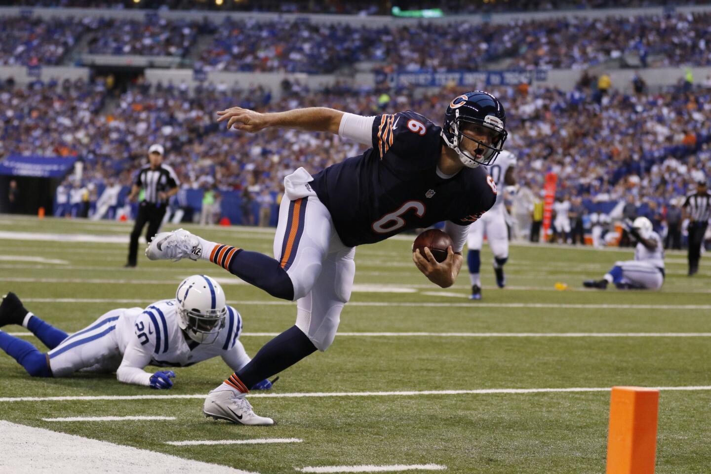 Bears quarterback Jay Cutler is tripped up by Colts cornerback Darius Butler in the first half.