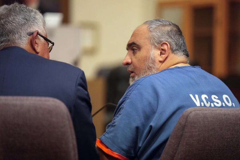 FILE - Attorney Ron Bamieh, left, listens to his client, Loay Abdelfattah Alnaji, a professor of computer science at Moorpark College, in Ventura County Superior Court on Nov. 17, 2023, in Ventura, Calif. A judge decided Wednesday, May 15, that Alnaji will stand trial for involuntary manslaughter and battery in the death of a Jewish counter-protester during demonstrations over the Israel-Hamas war last year. (AP Photo/Damian Dovarganes, File)