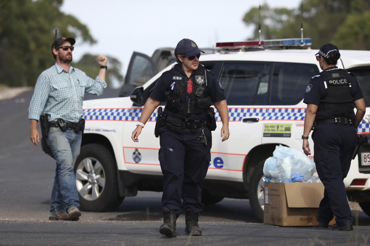 Police officers near the scene of a fatal shooting in Wieambilla, Australia