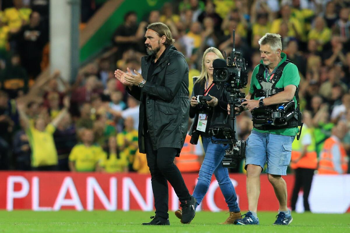 Norwich City's German head coach Daniel Farke (L) celebrates on the pitch after the English Premier League football match between Norwich City and Manchester City at Carrow Road in Norwich, eastern England on September 14, 2019. - Norwich won the game 3-2. (Photo by Lindsey Parnaby / AFP) / RESTRICTED TO EDITORIAL USE. No use with unauthorized audio, video, data, fixture lists, club/league logos or 'live' services. Online in-match use limited to 120 images. An additional 40 images may be used in extra time. No video emulation. Social media in-match use limited to 120 images. An additional 40 images may be used in extra time. No use in betting publications, games or single club/league/player publications. / LINDSEY PARNABY/AFP/Getty Images ** OUTS - ELSENT, FPG, CM - OUTS * NM, PH, VA if sourced by CT, LA or MoD **