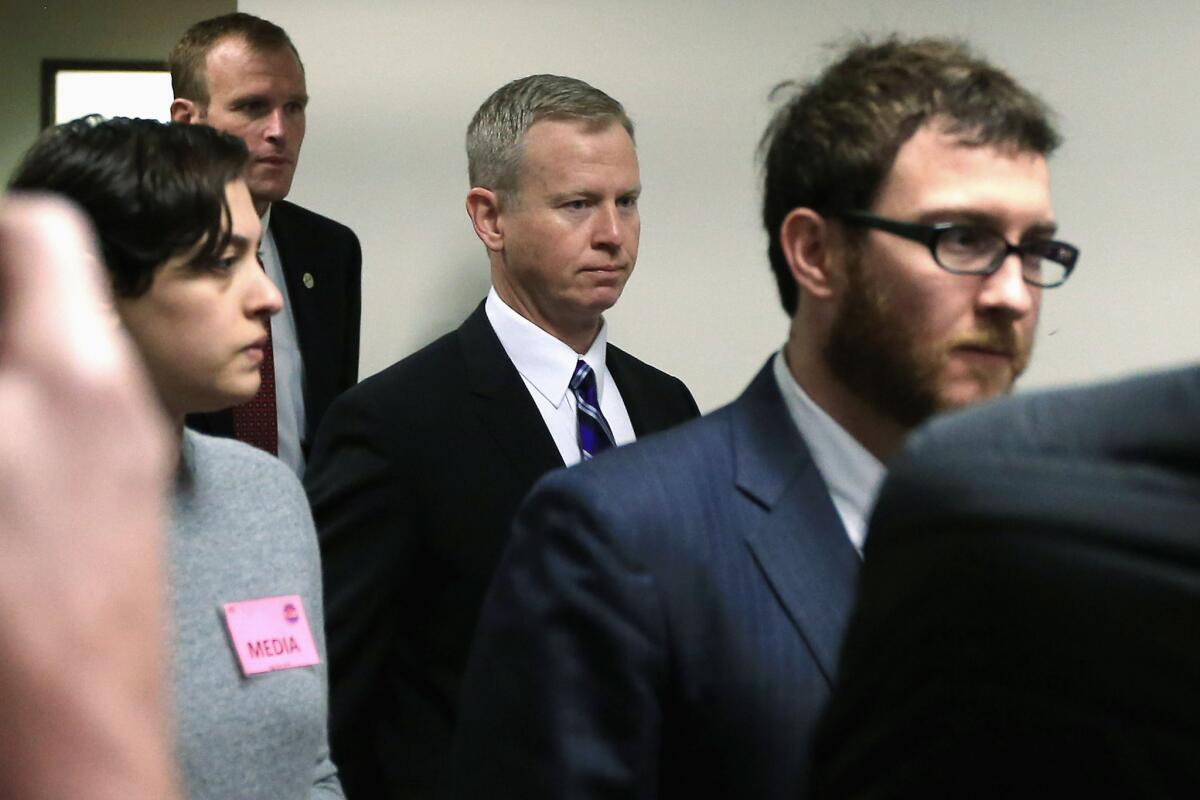 George Brauchler, center, District Attorney in Colorado's 18th Judicial District, arrives at the courtroom for a hearing on Aurora theater shooting suspect James Holmes.