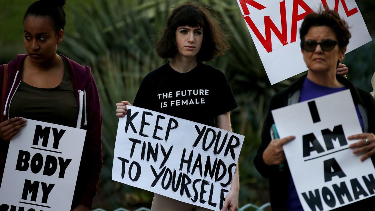 On Thursday, the eve of Donald Trump's inauguration, about 20 people rallied outside L.A. City Hall to show support for women's rights and survivors of sexual assault.