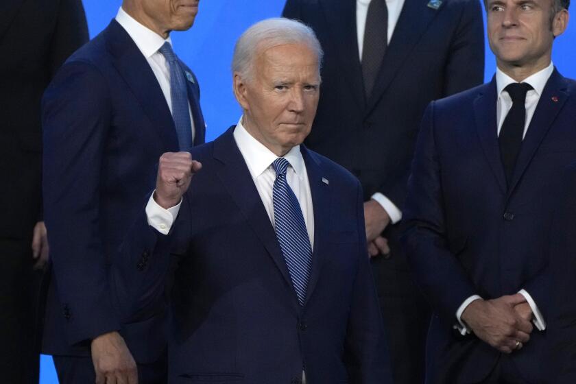 President Joe Biden pumps his fist as he poses with NATO leaders for an official photo at the NATO summit in Washington, Wednesday, July 10, 2024. (AP Photo/Mark Schiefelbein)
