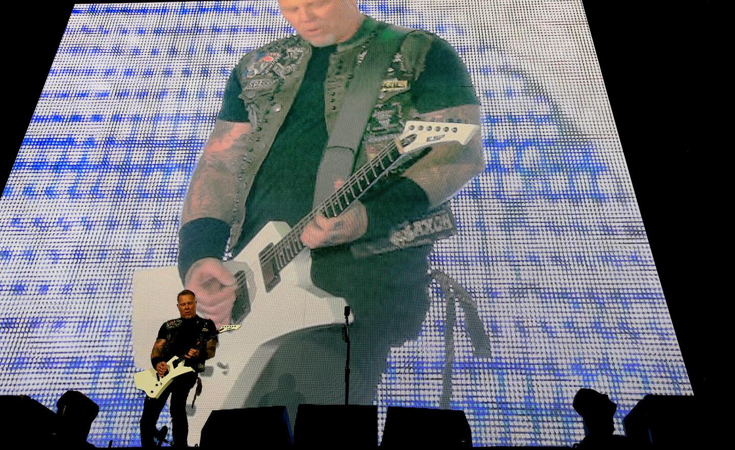 James Hetfield of Metallica on guitar fills up the large screen and the stage. He serenaded newlyweds with "Master of Puppets."