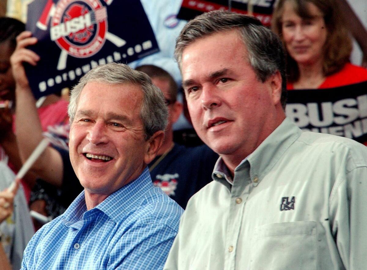 President George W. Bush with his brother. then-Florida Gov. Jeb Bush, at a campaign rally in October 2004.