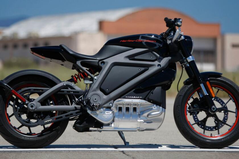 JUNE 17 2014. IRVINE, CA. "Live Wire", a prototype all electric motorcycle by Harley Davidson is unveiled to the media on the tarmac at the former Marine Corps Air Station El Toro in Irvine, CA, on June 17, 2014. The battery gives it a range of about 60 miles with a full recharge of 3 hours. The stripped down, full size, high-performance road bike can accelerate from 0-60 in 4 just seconds, but without the thunderous exhaust roar of a "Hog". A designer on hand for the rollout described its tone like that of a jet - a little jet. (Don Bartletti / Los Angeles Times)
