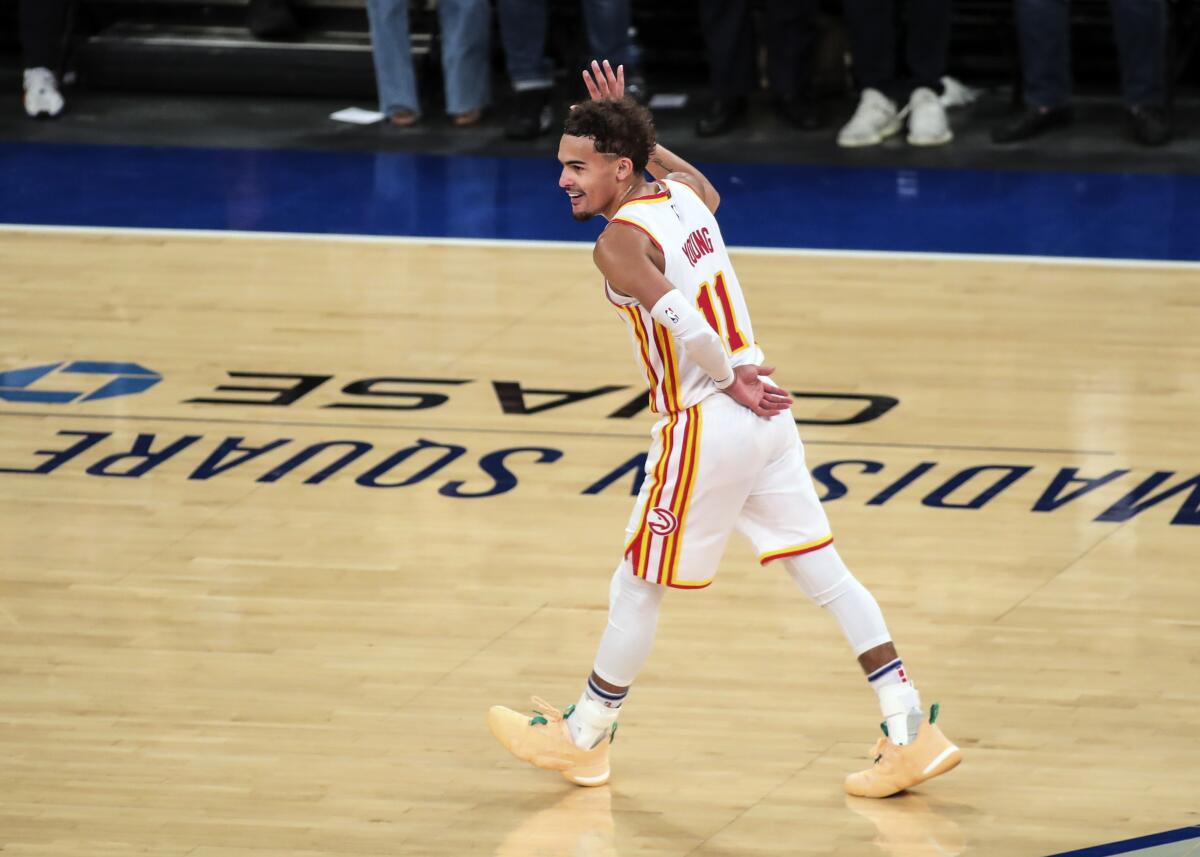 Atlanta Hawks guard Trae Young (11) waves to the crowd after making a three point shot against the New York Knicks in the fourth quarter of Game 5 of an NBA basketball first-round playoff series Wednesday, June 2, 2021, in New York. (Wendell Cruz/Pool Photo via AP)