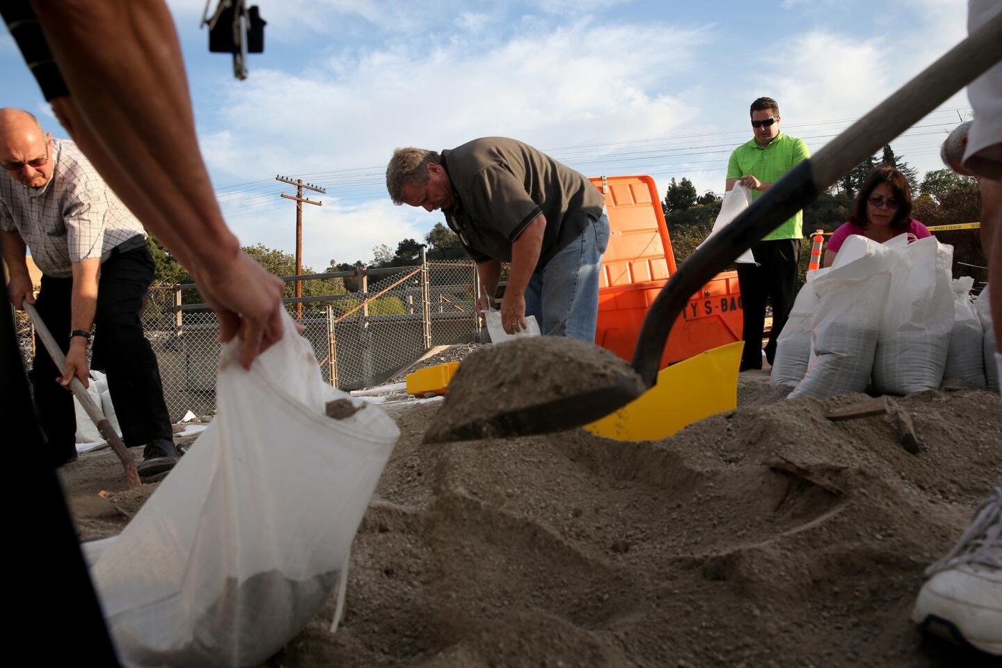 Glendora residents fill sandbags outside a city yard in preparation for possible flooding from expected heavy rains.