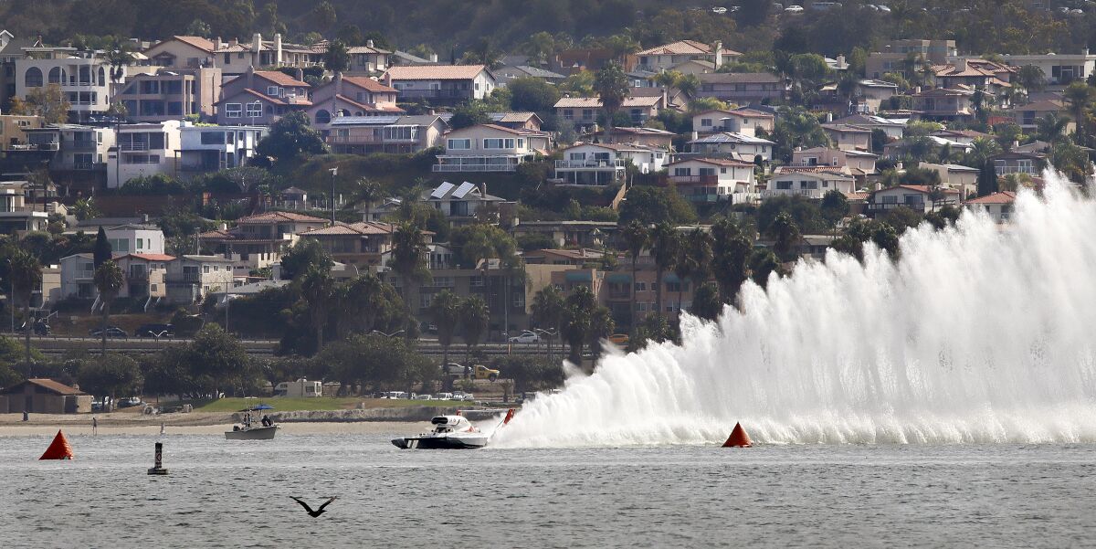 Unlimited hydroplane Miss Tri-Cities practices on the course at Mission Bay with Bay Park in the background. 