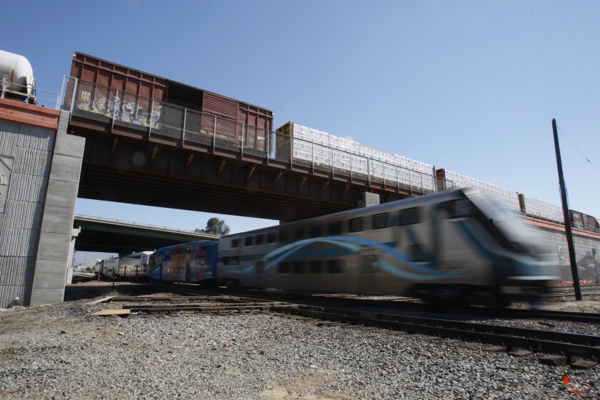 A Metrolink train passes in Colton. A board member for the commuter railroad resigned this week.